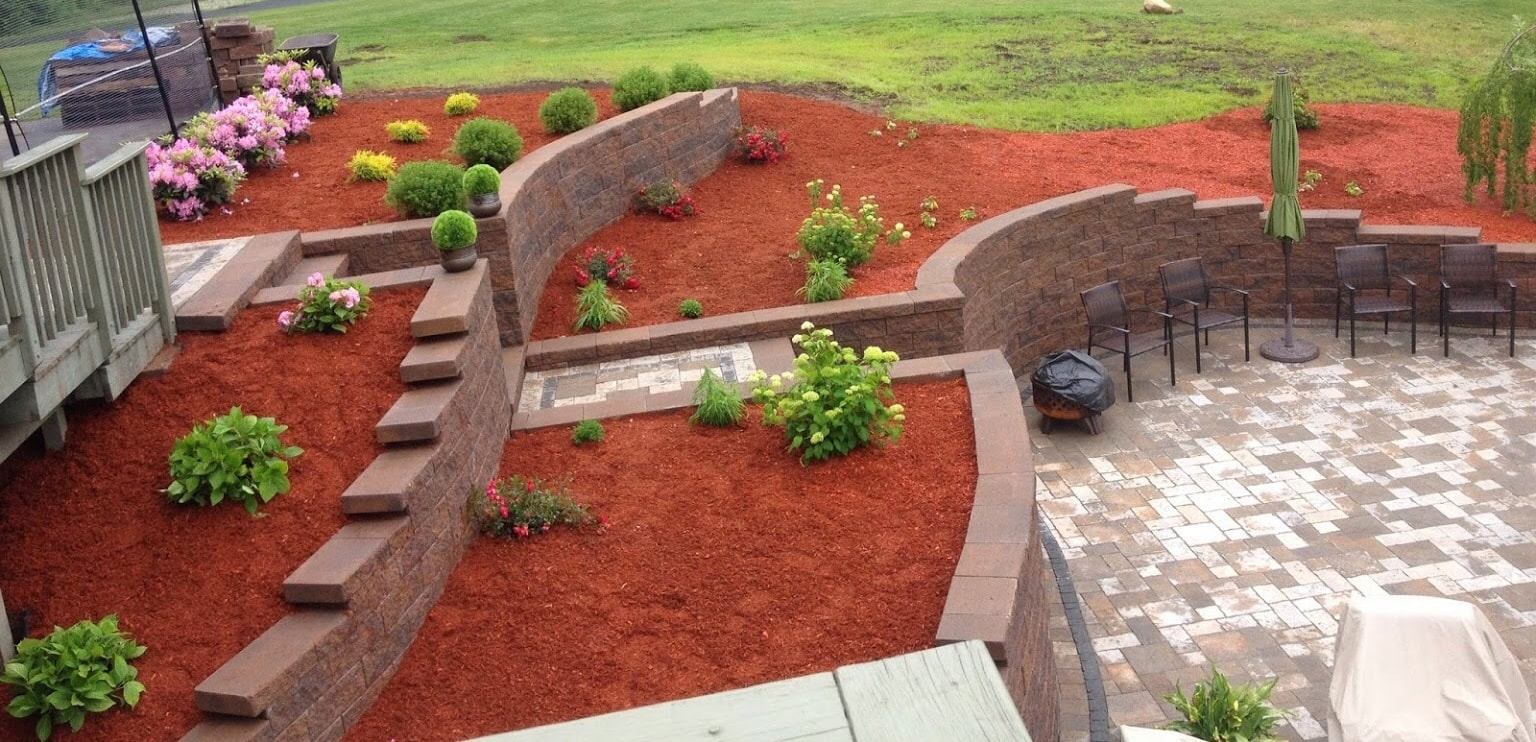 Landscape and Hardscape Job retaining walls, paver patio, paver walkway, red mulch and shrubs