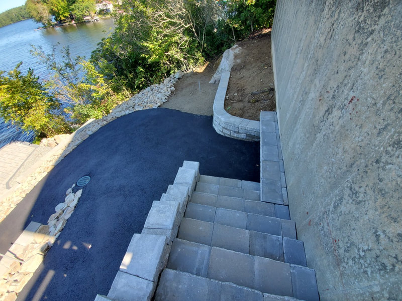 steep hill with steps retaining walls and patio in Hartford CT