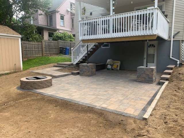 Hardscape with a firepit, decorative pavers patio, pavers pathway with steps, and cement block pillarsPicture